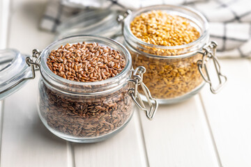 Linseed or flaxseed. Healthy flax seed in jar on white table.