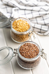 Linseed or flaxseed. Healthy flax seed in jar on white table.