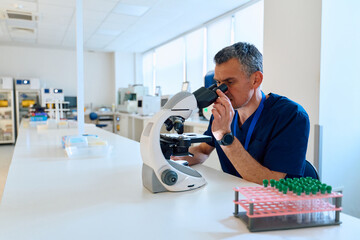 Microscopist examining samples in a modern laboratory during the afternoon