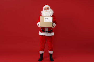 Santa Claus with parcel on red background