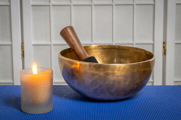 burning wax candle and Tibetan singing bowl, meditation and relaxation concept