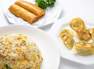 Delicious Asian food with dumplings, fried rice, and spring rolls