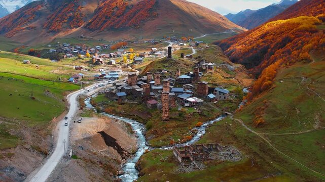 Lovely medieval village with tower houses located in the picturesque mountains. Flight over Ushguli village, Upper Svaneti, Georgia in autumn.