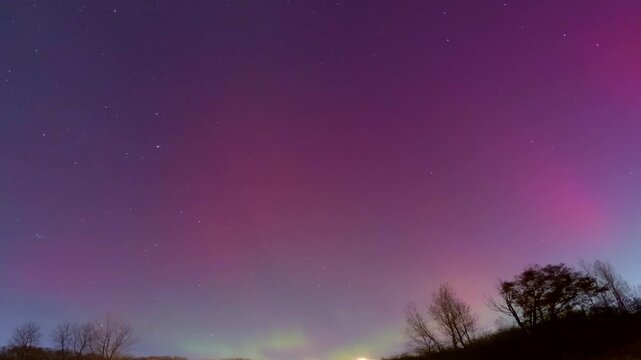 Beautiful night sky time lapse clouds and northern lights, seamless loop.