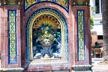 Fototapeta premium Panoramic view of a historic Spanish town with white houses and dramatic cloudy sky, showcasing traditional architecture and urban heritage.