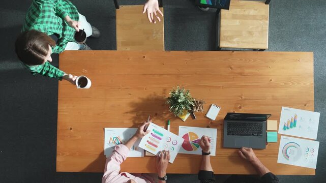 Top view of business team attend meeting while prepare working and analyzing data. Group of diverse people planning creative and working on start up project while team joining conference. Convocation.