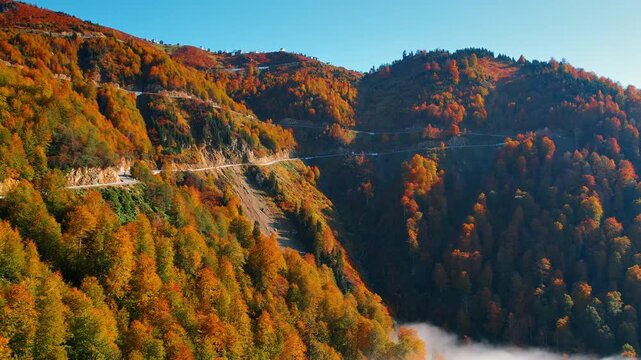 Eye-catching colorful mountains crossed by the road. Multiple houses are located on the top of the rocks. Beautiful Georgia.