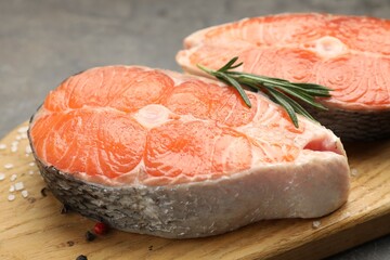 Pieces of salmon fillet with spices on table, closeup