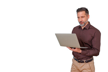Mature businessman working on laptop, managing online business, standing professionally with transparent background