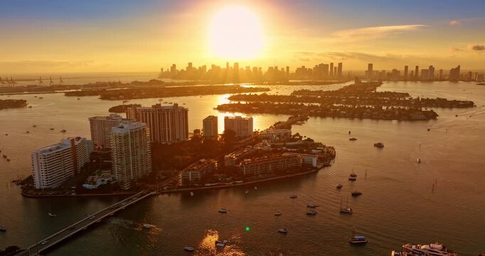 Fantastic sunset over Biscayne Bay, Miami, USA. Footage above the man-made islands and multiple boats on the water.