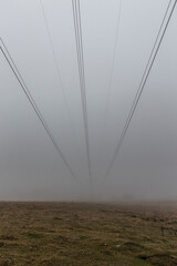 
A power transmission line shrouded in fog.