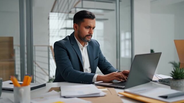 Focused businessman working diligently on his laptop at his desk Stock Video