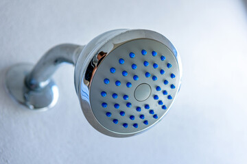 Silver shower head with blue water detail