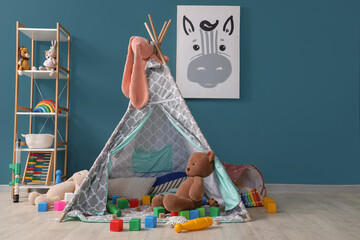 Interior of messy children's room with play tent and scattered toys