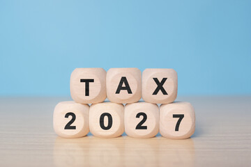 TAX in 2027 concept, on wooden block. State taxes,tax payment, governant ,calculating finance, tax accounting, statistics and data analytic reserach, calculation tax return, strategy plan, report