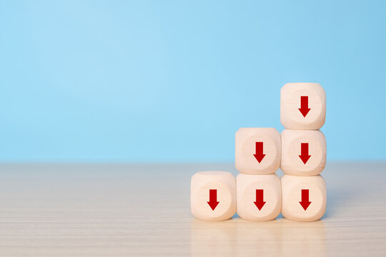Business decline, performance decrease arrow drop down. Market loss concept diagram in arrow chart wooden block.