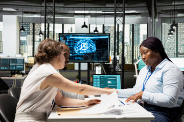 Obraz premium HR staff members using AI tech platforms and deep learning algorithms to analyze CV resumes and help with selecting candidates to fill in corporate vacancy. Workforce potential.