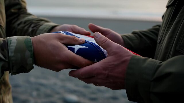 Close up of soldier hands holding a folded American flag with respect during a beach ceremony at sunset, symbolizing military honor and sacrifice for veterans.