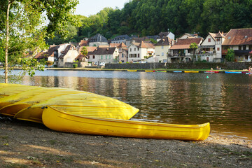 Beach and kayaks at Beaulieu-sur-Dordogne village in France
