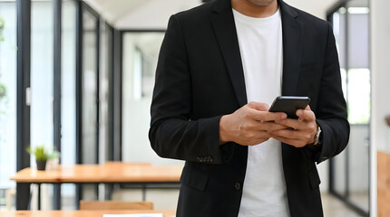 Businessman using smartphone in modern office space