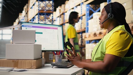 Black female customer support clerk speaks with clients about shipment details, helping with wrong...