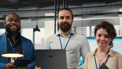 Portrait of multiethnic employees work with performance metrics and high tech, aligning business...