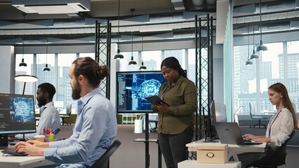 Female programmer coding AI algorithms on tablet to debug software issues and improving system stability. Woman in tech startup office configuring settings using device, camera A