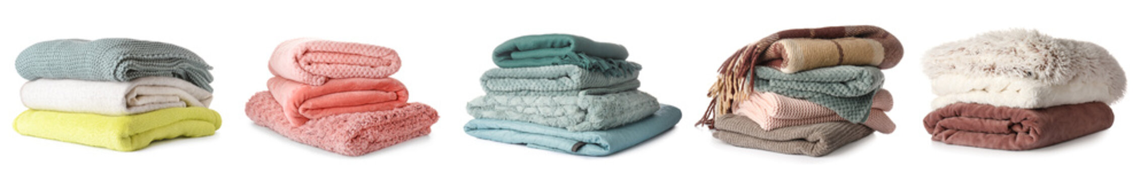 Set of soft folded blankets on white background