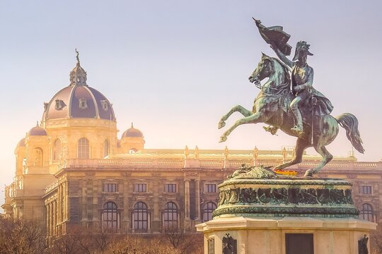 The equestrian statue of the Archduke Charles and the Museum of Natural History dome during a sunset in Vienna, Austria