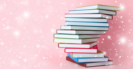 Stack of books on color background