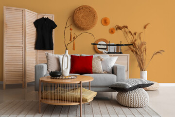 Interior of light living room with sofa, table and decor for Chinese New Year celebration