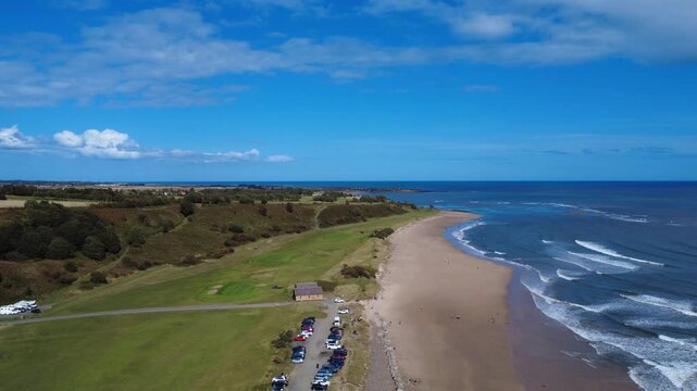 scenic aerial view of the beach at alnmouth in northumbria with coastal scenery and a blue sunlit sea
