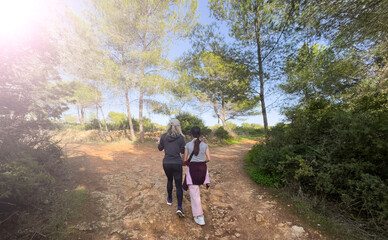 Fototapeta premium Young mother and daughter hiking