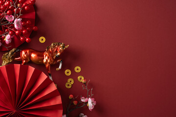 A vibrant red backdrop features a decorative horse, gold coin accents, a red paper fan, and blossoms, capturing Chinese New Year celebration and warm greeting for luck prosperity and success