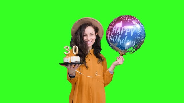 Smiling woman holding balloon, birthday cake with number 30 on the chroma key