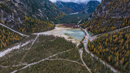 aerial view of mountain landscape in the H&ouml;hlensteintal with D&uuml;rrensee, a picturesque mountain lake (almost dried out)  near Toblach, situated  in the Sexten Dolomites in South Tyrol, in autumn