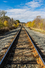 Fototapeta premium Railway line of a Canadian freight train company where it crosses the Hamilton city in Ontario, Canada, during the autumn.