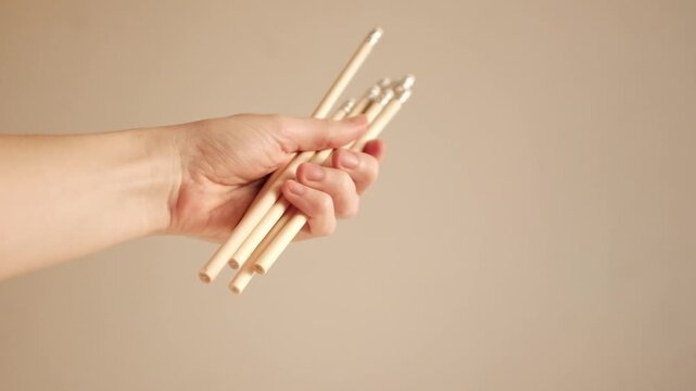 Closeup slow motion video of wooden graphite pencils. Simple minimalist pencils in Scandi style. School stationery in aesthetic colors. Back to school and educational concept. 