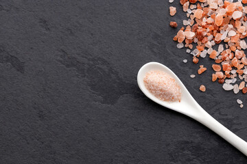 Fine salt and pink Himalayan crystals on the spoon