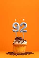 Birthday candle number 92 - Invitation card with orange background. Cupcake