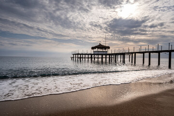 Old Pier Standing Over Calm Sea Water. Abandoned Pier Over the Sea. Deserted Wooden Pier in Seascape. Lonely Abandoned Dock Extending into the Ocean.