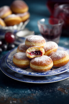Traditional sweet donuts with powdered sugar and jam. Fat Thursday or Hanukkah celebration. freshly baked jelly donuts stack 