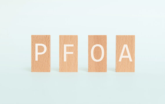 There is wood block with the word PFOA. It is an abbreviation for Per Fluoro Octanoic Acid as eye-catching image.