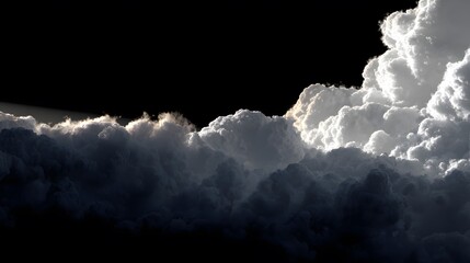 Dramatic white storm clouds emerging from darkness against black sky creating powerful moody atmospheric scene
