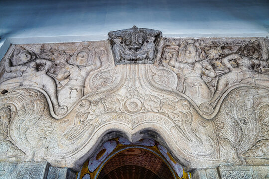 Makara Torana at the entrance to the temple - a carved stone arch with a dragon like figure flanked by guardian dieties at the Temple of the Tooth,Sri Dalada Maligawa,built in 1595 in Kandy,Sri Lanka