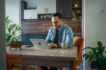 Man working remotely from home using laptop