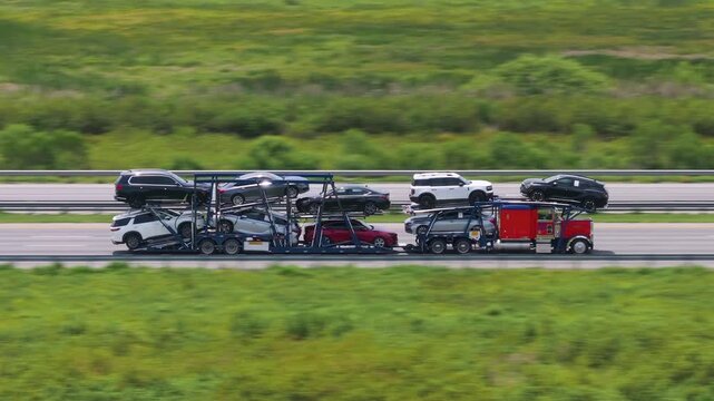 Auto hauler truck carrying new and used cars on multi-level trailer as part of nationwide vehicle distribution.