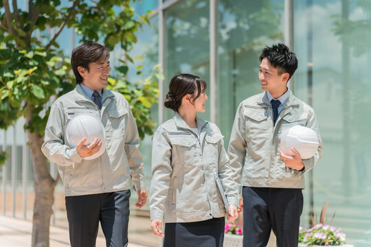 Work clothes at the construction site, construction industry in work clothes, male and female staff in the building industry