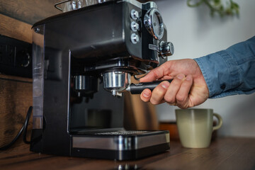 Man make coffee on home espresso coffee machine