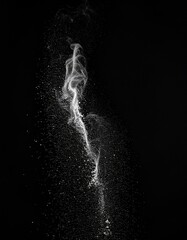 Abstract White Stream with Scattered Dots on Black Background in Studio Shot